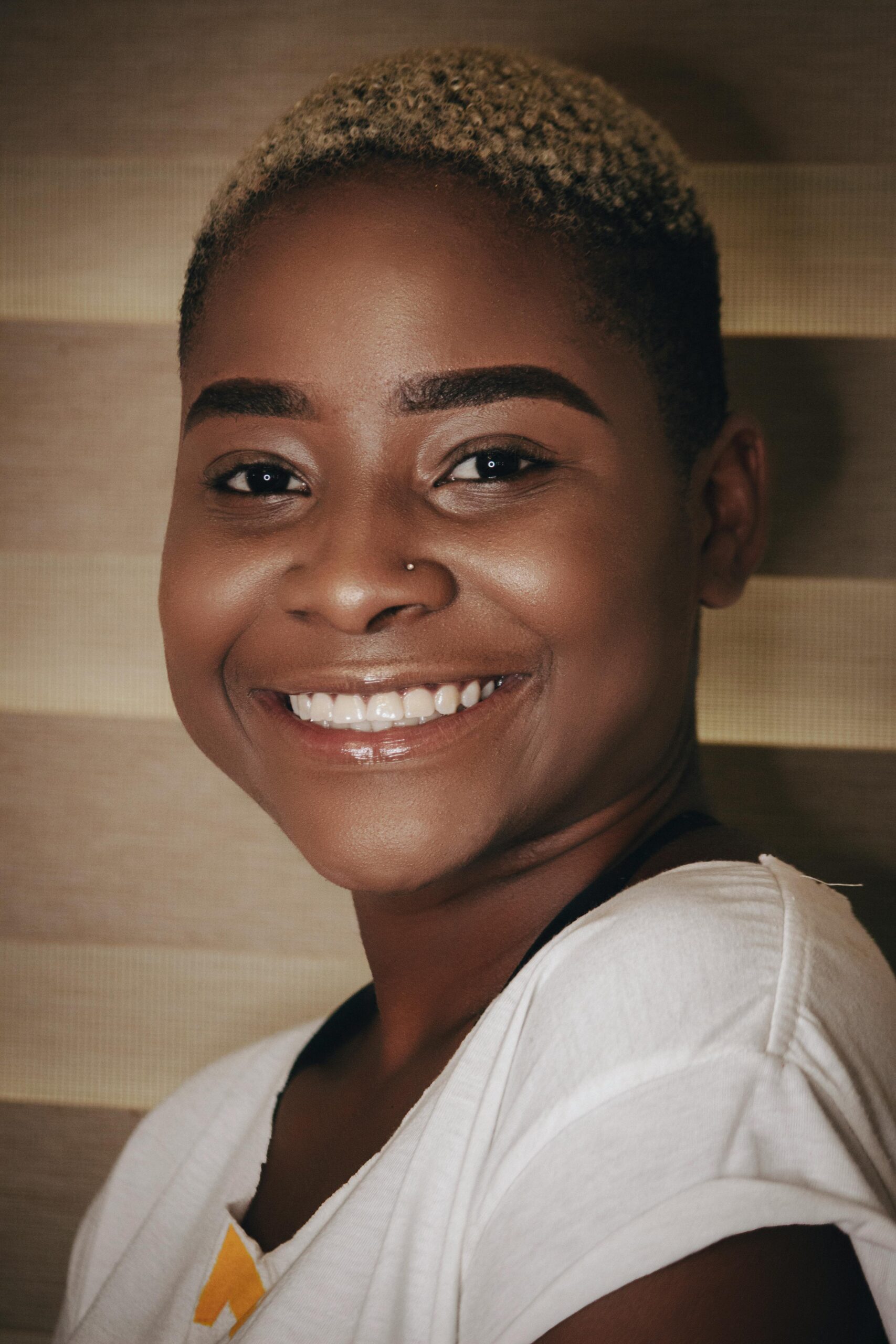 Joyful portrait of an African woman with short hair, radiating happiness.